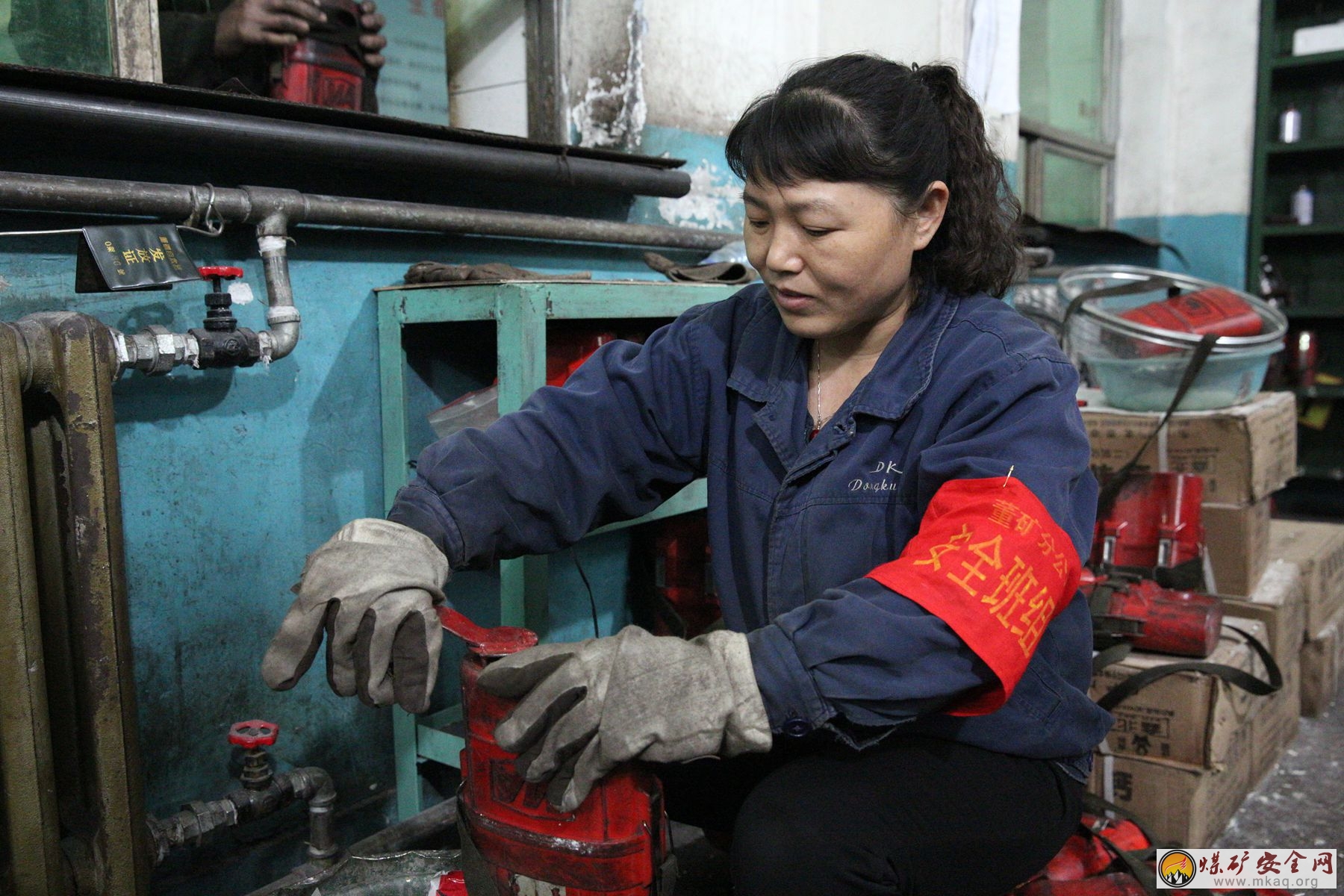 陝煤澄合董礦分公司通風區自救器房女工對自救器進行檢查維修。